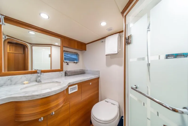 Smile Smile Smile Yacht Photos Pics Luxurious bathroom in 2022 Outer Reef 720 Motor Yacht with marble countertop and modern fixtures.