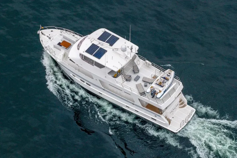 Smile Smile Smile Yacht Photos Pics 2022 Outer Reef 720 Motor Yacht cruising on open water, aerial view.
