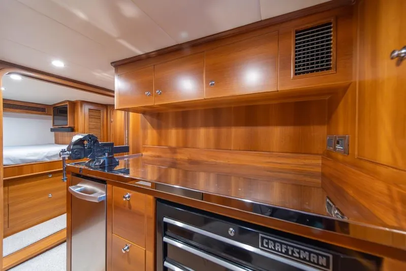 Smile Smile Smile Yacht Photos Pics Luxurious wood-finished interior of 2022 Outer Reef 720 Motor Yacht with modern amenities.