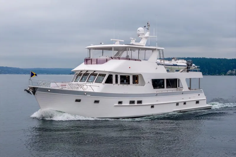 Smile Smile Smile Yacht Photos Pics 2022 Outer Reef 720 Motor Yacht cruising on calm waters under cloudy skies.