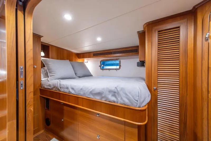 Smile Smile Smile Yacht Photos Pics Luxurious cabin interior of 2022 Outer Reef 720 Motor Yacht with wooden finishes.