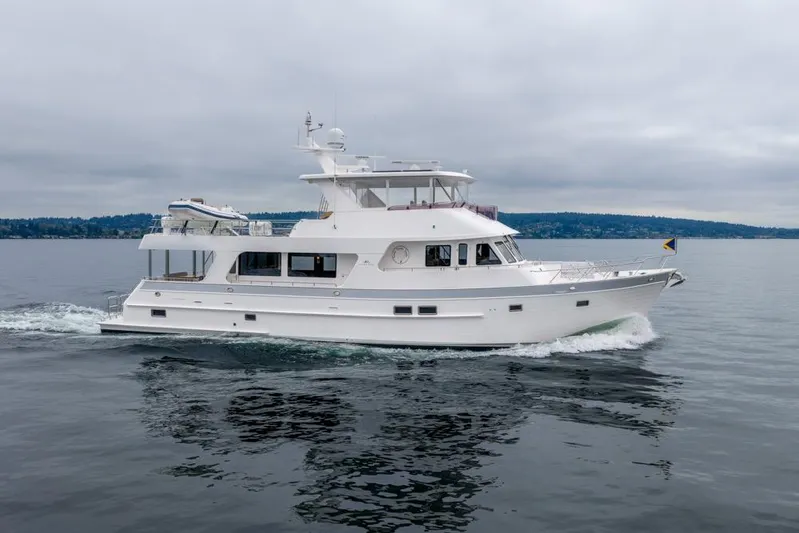 Smile Smile Smile Yacht Photos Pics 2022 Outer Reef 720 Motor Yacht cruising on calm waters under cloudy skies.