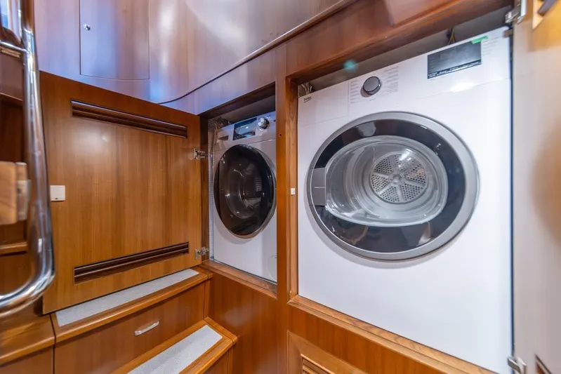 Smile Smile Smile Yacht Photos Pics Laundry area with washer and dryer on 2022 Outer Reef 720 Motor Yacht.