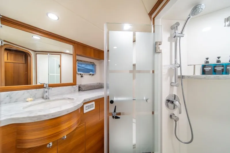 Smile Smile Smile Yacht Photos Pics Luxurious bathroom in 2022 Outer Reef 720 Motor Yacht with modern fixtures and marble countertop.