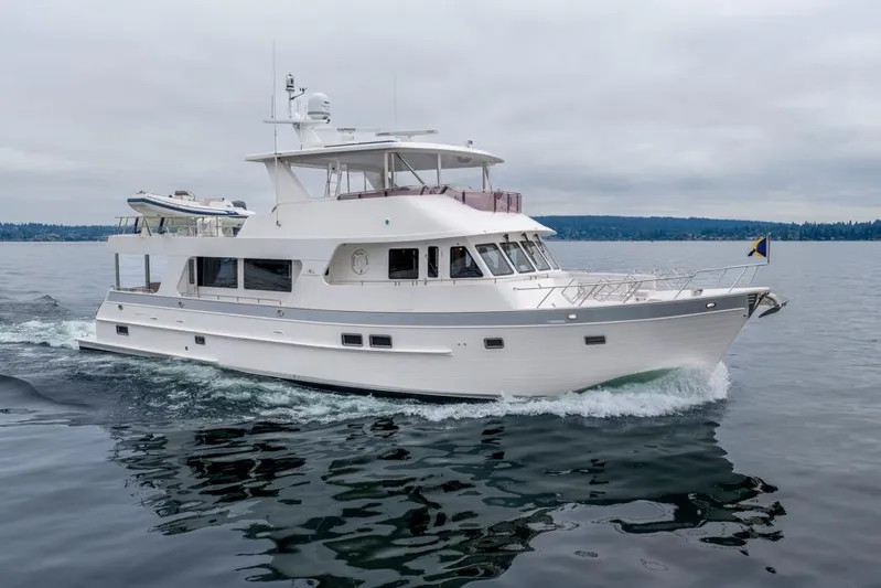 Smile Smile Smile Yacht Photos Pics 2022 Outer Reef 720 Motor Yacht cruising on calm waters under cloudy skies.