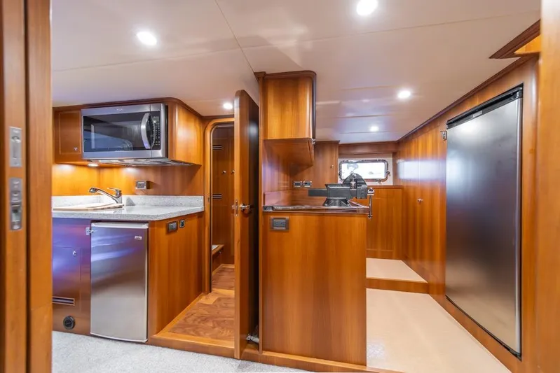 Smile Smile Smile Yacht Photos Pics Luxurious kitchen interior of 2022 Outer Reef 720 Motor Yacht with modern appliances.