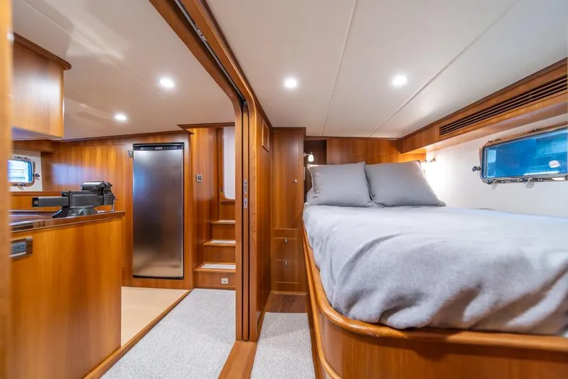 Smile Smile Smile Yacht Photos Pics Luxurious interior of 2022 Outer Reef 720 Motor Yacht with cozy bedroom and modern amenities.