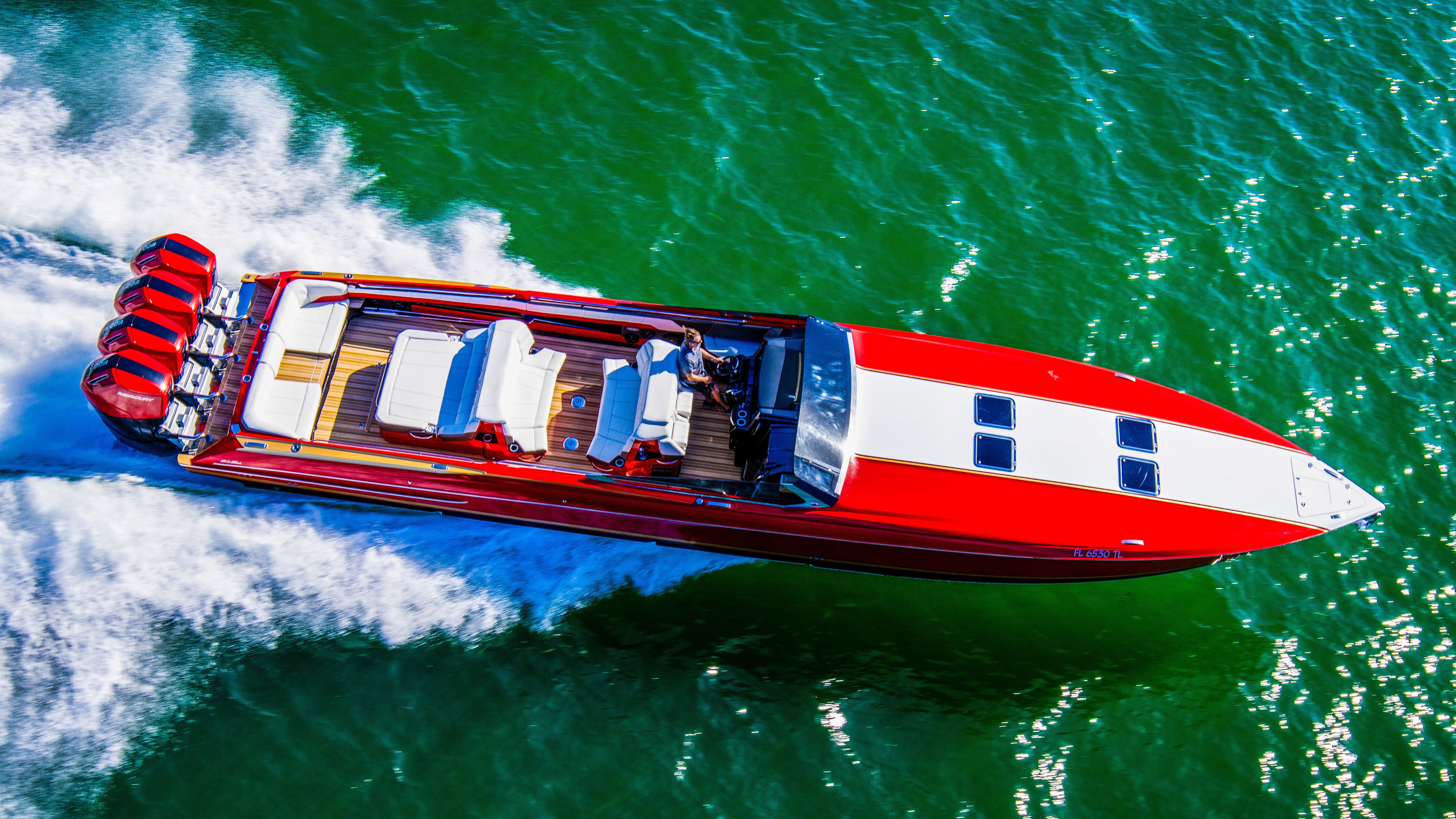 2026 Nor-Tech 550 & 560 Sport Center Console, red and white, cruising on water.