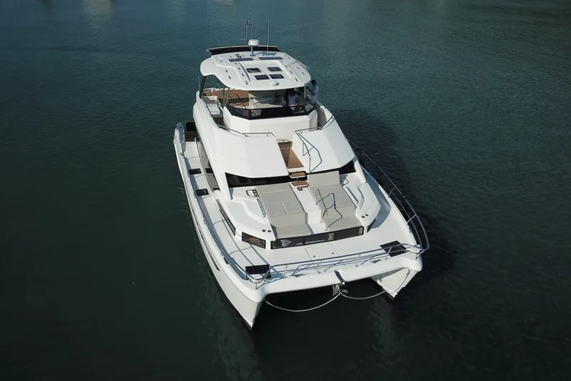  Yacht Photos Pics 2025 Aquila 54 Yacht on calm water, aerial view.