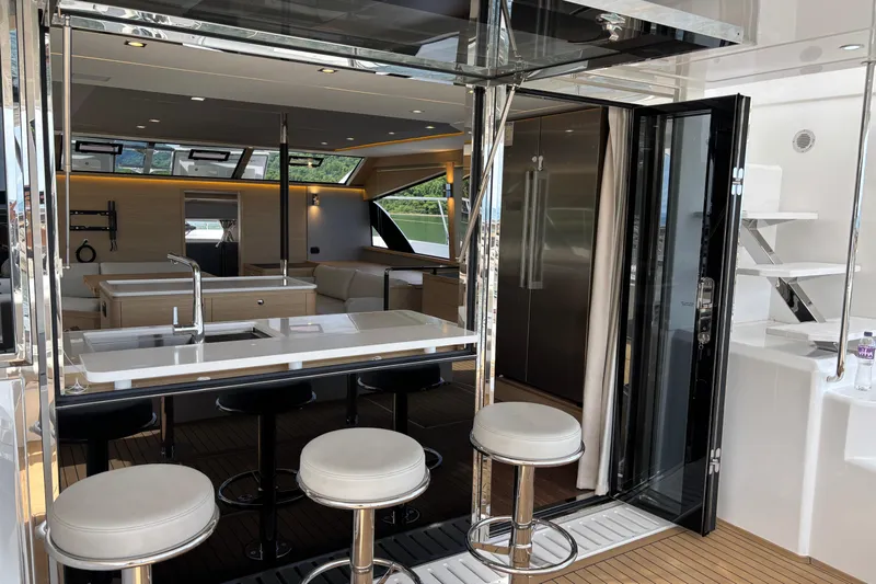  Yacht Photos Pics Luxurious interior of 2025 Aquila 54 Yacht with modern kitchen and seating area.
