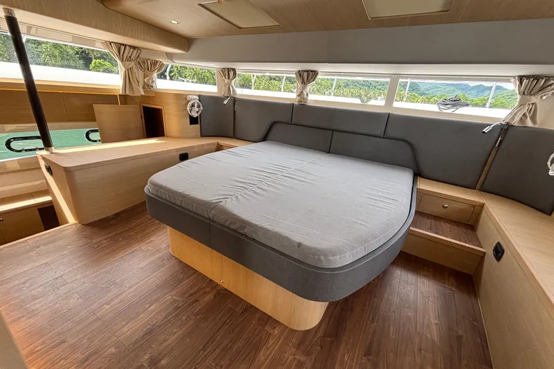  Yacht Photos Pics Luxurious interior of 2025 Aquila 54 Yacht with spacious bed and elegant wood finish.