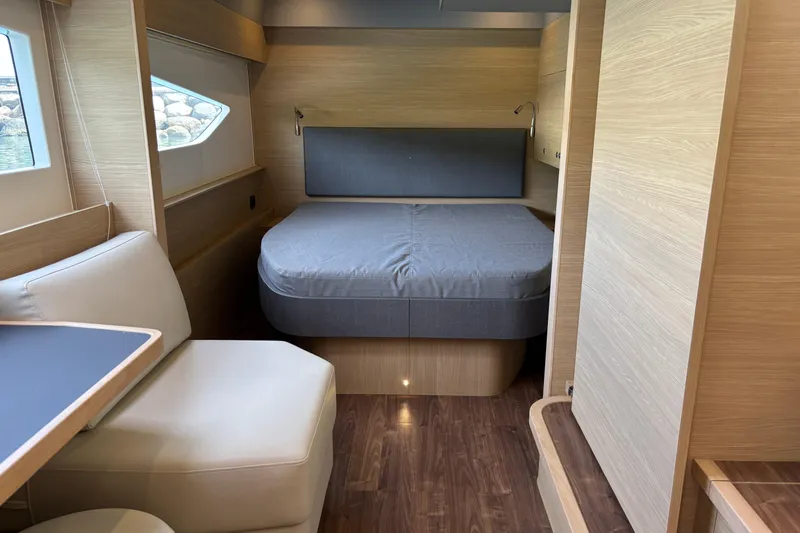  Yacht Photos Pics Interior of 2025 Aquila 54 Yacht with modern wood finish and cozy sleeping area.