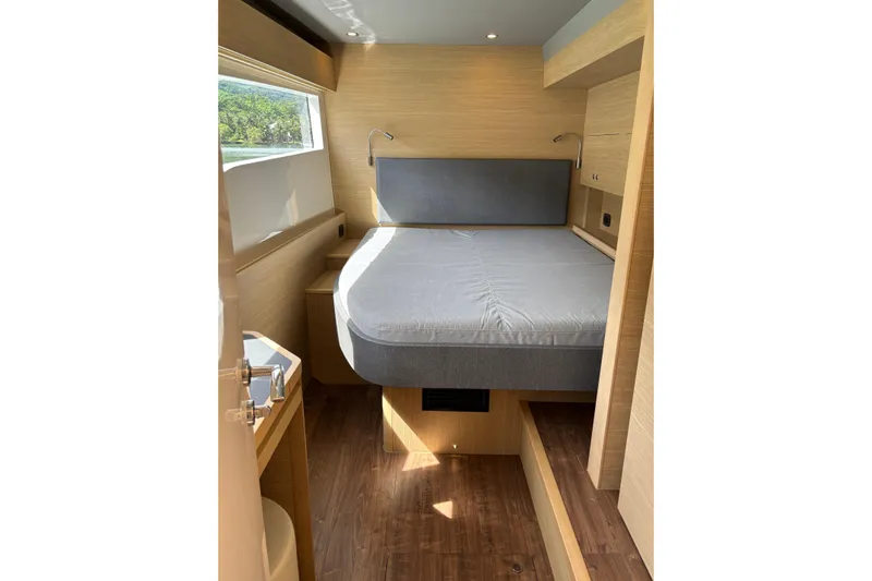  Yacht Photos Pics Modern bedroom interior of 2025 Aquila 54 Yacht with sleek design and natural lighting.