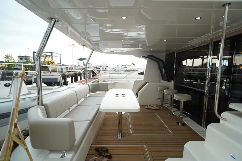 Yacht Photos Pics Luxurious 2025 Aquila 54 Yacht deck with seating, table, and bar stools.