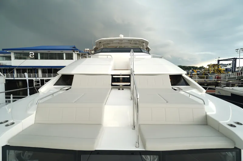  Yacht Photos Pics 2025 Aquila 54 Yacht with sleek design and spacious deck at marina.