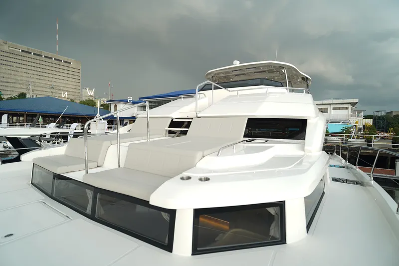  Yacht Photos Pics 2025 Aquila 54 Yacht with sleek design and spacious deck at marina.