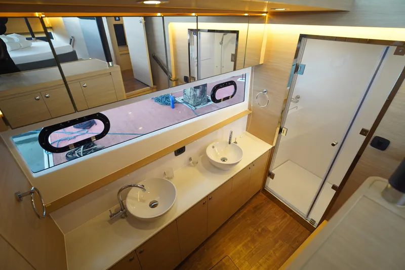  Yacht Photos Pics Luxurious bathroom interior of 2025 Aquila 54 Yacht with dual sinks and shower.