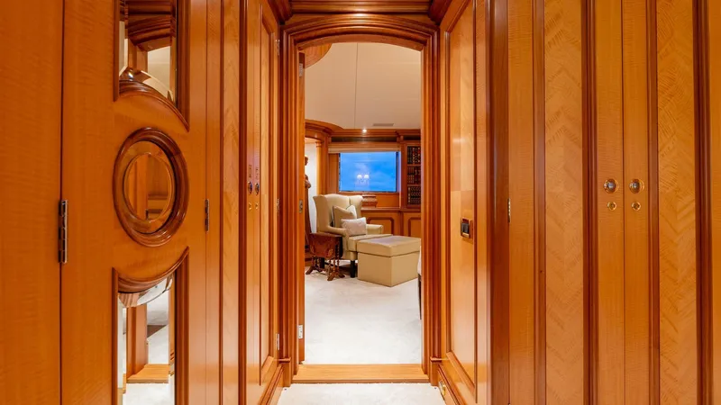 Amanti Yacht Photos Pics Luxurious interior hallway of 2003 Feadship 51.8M yacht with wooden paneling.