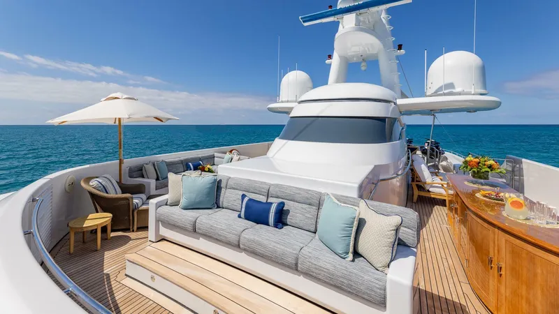 Amanti Yacht Photos Pics Luxurious 2003 Feadship 51.8M yacht deck with seating, ocean view, and bar.