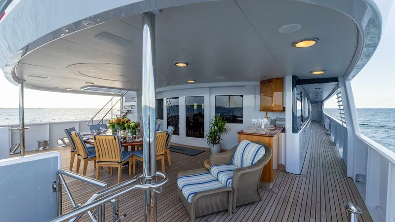 Amanti Yacht Photos Pics Luxurious deck of 2003 Feadship 51.8M yacht with outdoor dining and seating area.