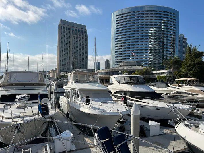 Broker Of Venice Yacht Photos Pics Marina with 1988 Sea Ranger aft cabin yacht, surrounded by modern buildings and clear skies.