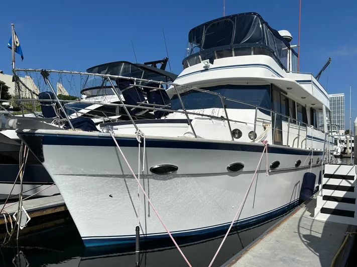 Broker Of Venice Yacht Photos Pics 1988 Sea Ranger aft cabin yacht docked at marina, featuring sleek design and spacious deck.