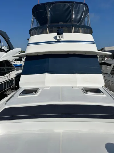 Broker Of Venice Yacht Photos Pics 1988 Sea Ranger aft cabin boat docked, featuring sleek design and spacious deck.