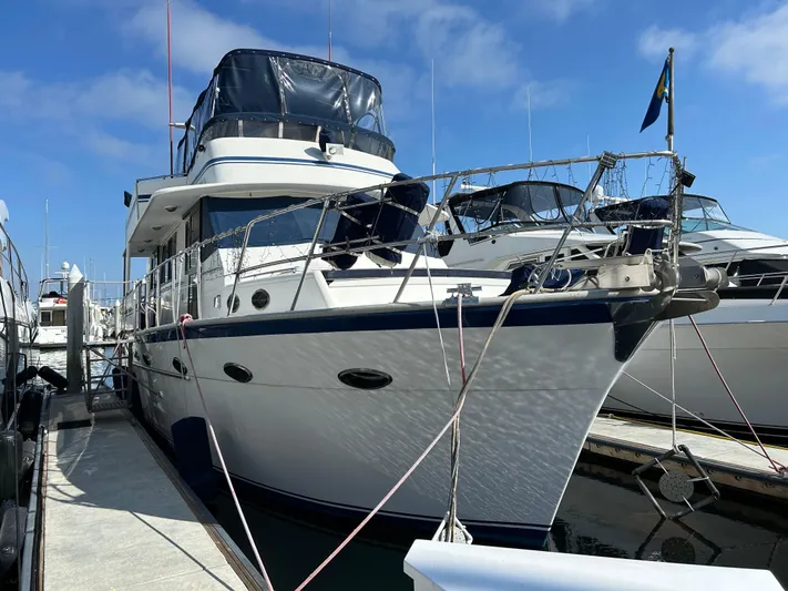 Broker Of Venice Yacht Photos Pics 1988 Sea Ranger aft cabin yacht docked at marina under clear blue sky.