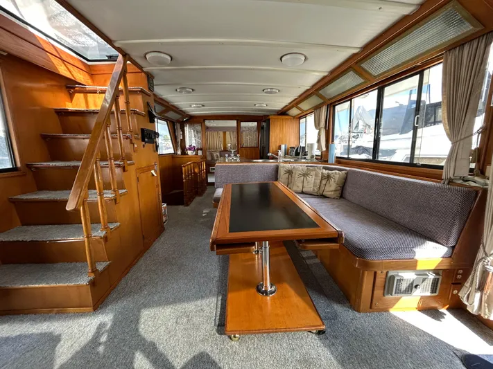 Broker Of Venice Yacht Photos Pics 1988 Sea Ranger aft cabin interior with wood finish, seating, and table.
