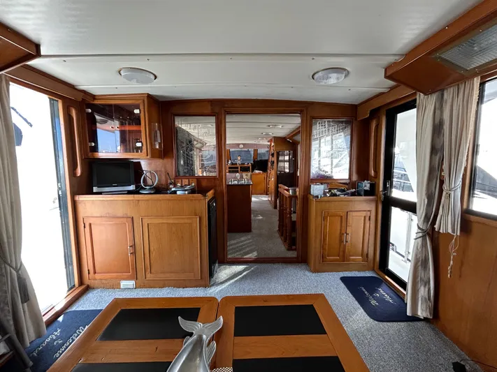Broker Of Venice Yacht Photos Pics 1988 Sea Ranger aft cabin interior with wooden cabinetry, carpeted floor, and natural light.
