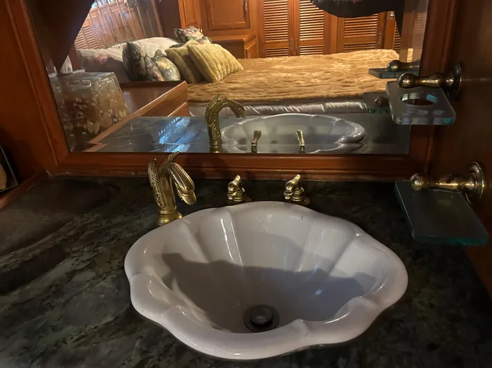 Broker Of Venice Yacht Photos Pics Luxurious bathroom sink in 1988 Sea Ranger aft cabin yacht, featuring elegant brass fixtures.