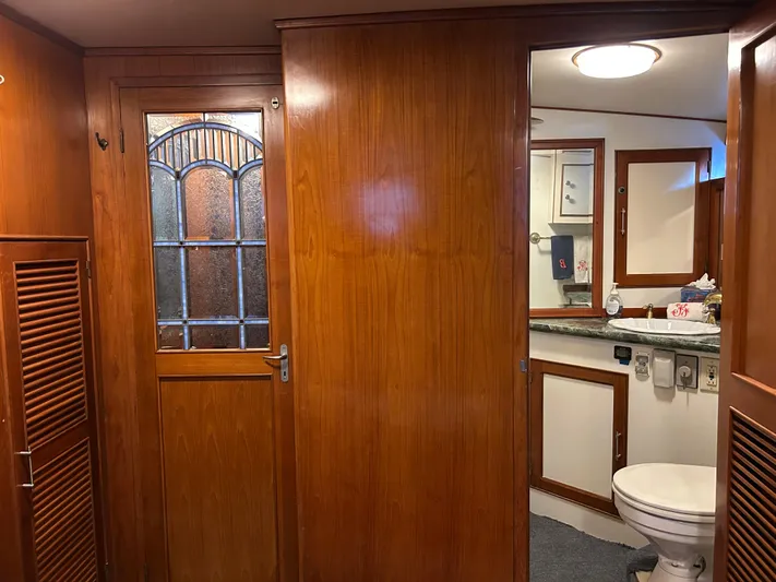 Broker Of Venice Yacht Photos Pics 1988 Sea Ranger aft cabin interior with wooden paneling and bathroom view.