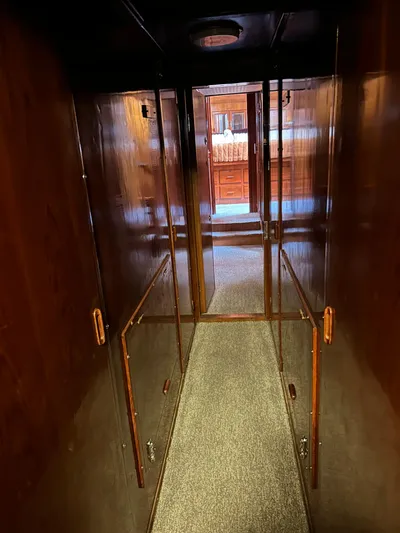 Broker Of Venice Yacht Photos Pics 1988 Sea Ranger aft cabin interior with wooden walls and carpeted hallway.