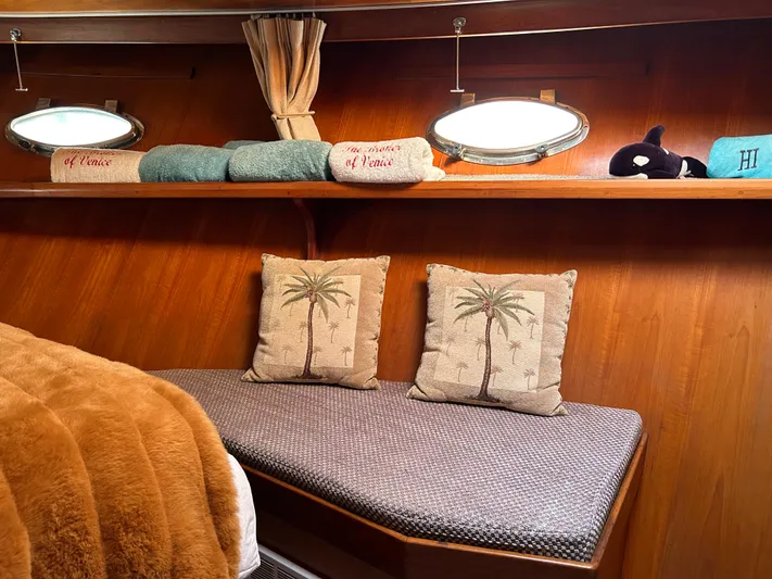 Broker Of Venice Yacht Photos Pics 1988 Sea Ranger aft cabin with cozy seating, palm tree pillows, and nautical decor.