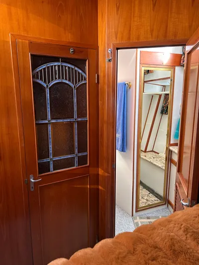 Broker Of Venice Yacht Photos Pics 1988 Sea Ranger aft cabin interior with wooden doors and mirror, showcasing classic nautical design.