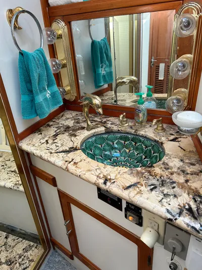 Broker Of Venice Yacht Photos Pics Luxurious 1988 Sea Ranger aft cabin bathroom with marble countertop and elegant fixtures.