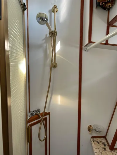 Broker Of Venice Yacht Photos Pics 1988 Sea Ranger aft cabin shower with handheld showerhead and wooden trim.