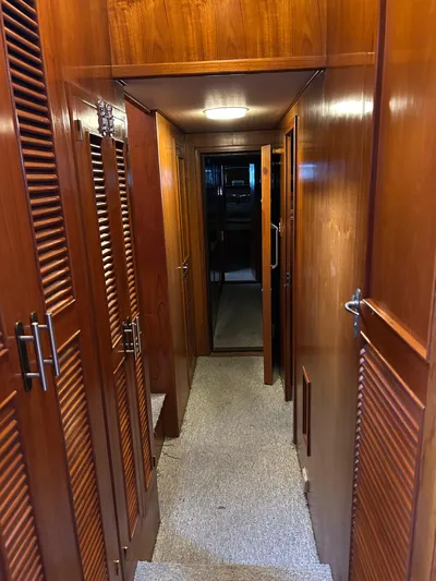 Broker Of Venice Yacht Photos Pics 1988 Sea Ranger aft cabin interior with wooden paneling and carpeted hallway.