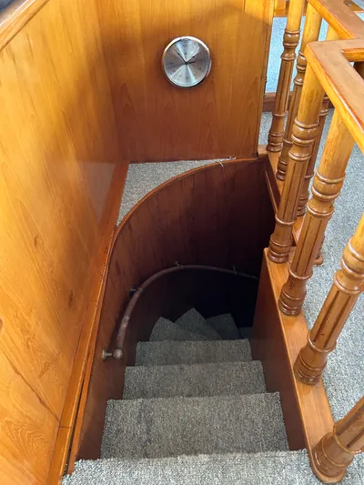 Broker Of Venice Yacht Photos Pics Staircase in 1988 Sea Ranger aft cabin with wooden railings and carpeted steps.