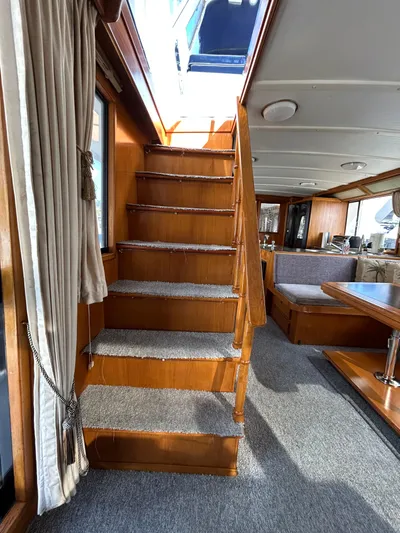 Broker Of Venice Yacht Photos Pics Interior of 1988 Sea Ranger aft cabin with wooden stairs and carpeted floor.