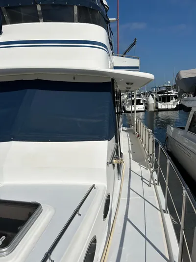 Broker Of Venice Yacht Photos Pics 1988 Sea Ranger aft cabin yacht docked at marina under clear blue sky.