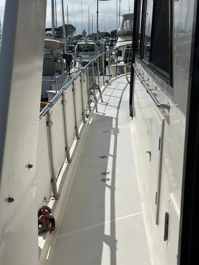 Broker Of Venice Yacht Photos Pics 1988 Sea Ranger aft cabin yacht deck with railing, docked at marina.