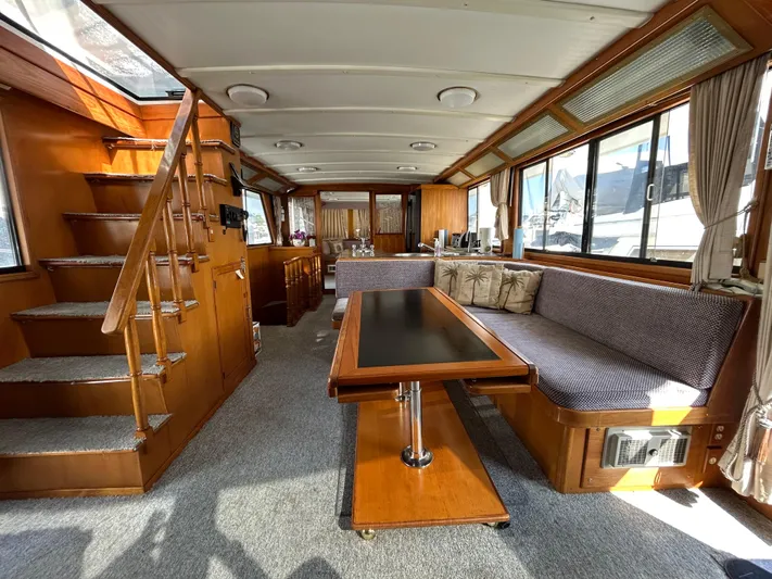 Broker Of Venice Yacht Photos Pics 1988 Sea Ranger aft cabin interior with wood finishes, spacious seating, and large windows.