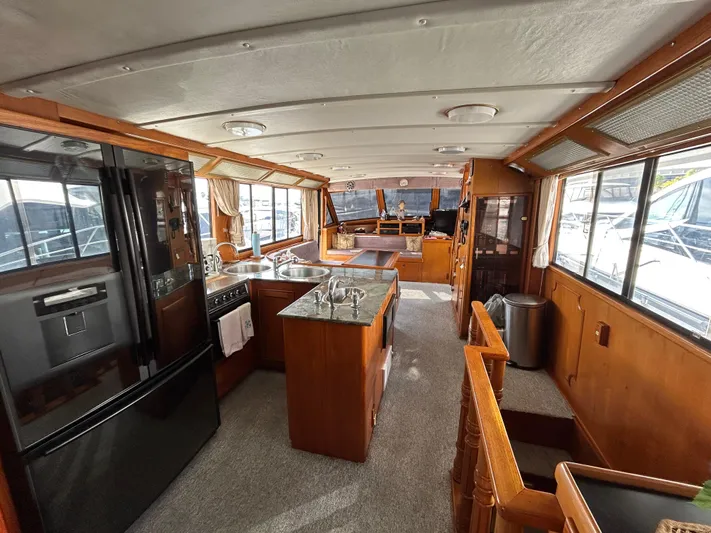 Broker Of Venice Yacht Photos Pics Interior of 1988 Sea Ranger aft cabin yacht with modern kitchen and spacious living area.
