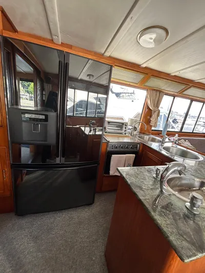 Broker Of Venice Yacht Photos Pics 1988 Sea Ranger aft cabin kitchen with modern appliances and granite countertops.