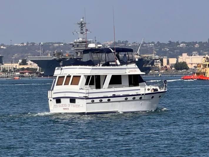 Broker Of Venice Yacht Photos Pics 1988 Sea Ranger aft cabin yacht cruising in a busy harbor.