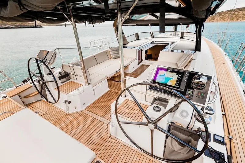 Dictador Yacht Photos Pics Luxurious 2022 Beneteau Oceanis Yacht 62 cockpit with dual steering wheels and navigation equipment.