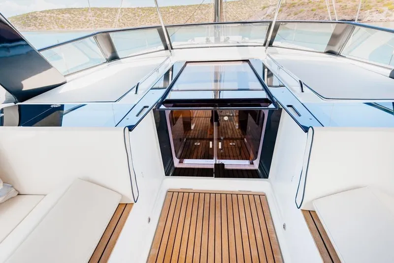 Dictador Yacht Photos Pics Luxurious deck of 2022 Beneteau Oceanis Yacht 62 with sleek design and wooden flooring.