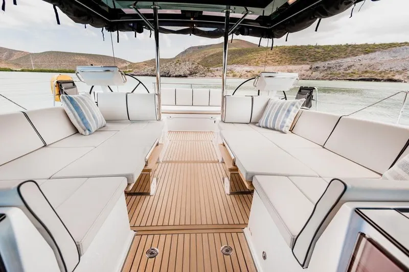 Dictador Yacht Photos Pics Luxurious 2022 Beneteau Oceanis Yacht 62 interior with elegant seating and scenic water view.