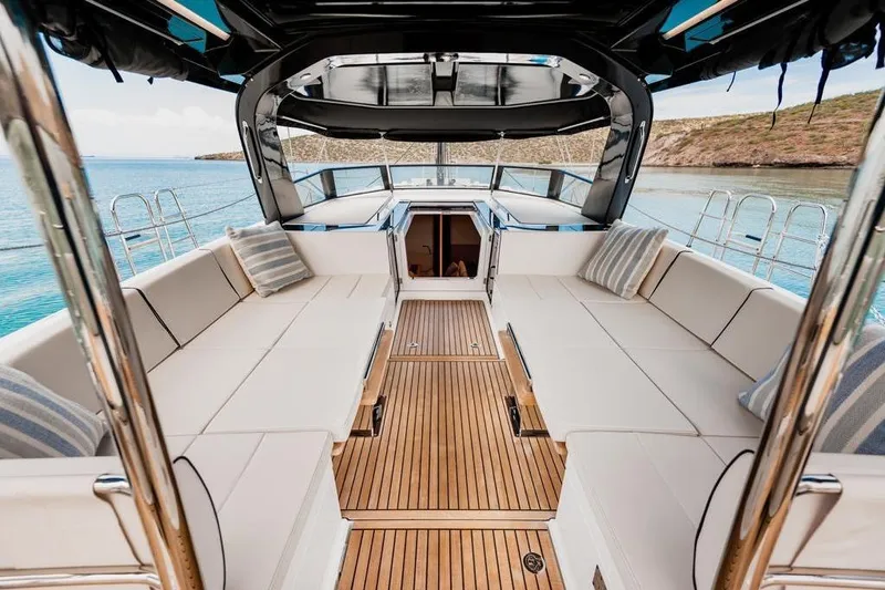 Dictador Yacht Photos Pics Luxurious 2022 Beneteau Oceanis Yacht 62 deck with elegant seating and scenic ocean view.
